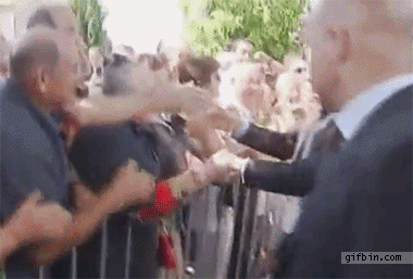 1309955158_man_yanks_sarkozy_by_the_shoulder.gif